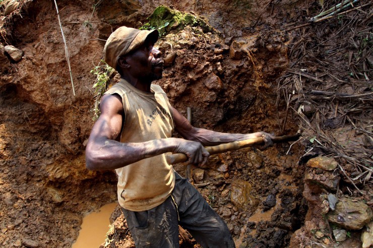 In this photo taken Aug. 17, 2012, one of the few remaining miners digs out soil which will later be filtered for traces of cassiterite, the major ore of tin, at Nyabibwe mine, in eastern Congo. Gold is now the primary source of income for armed groups in eastern Congo, and is ending up in jewelry stores across the world, according to a report published Thursday, Oct. 25, 2012, by the Enough Project. CREDIT: AP Photo/Marc Hofer