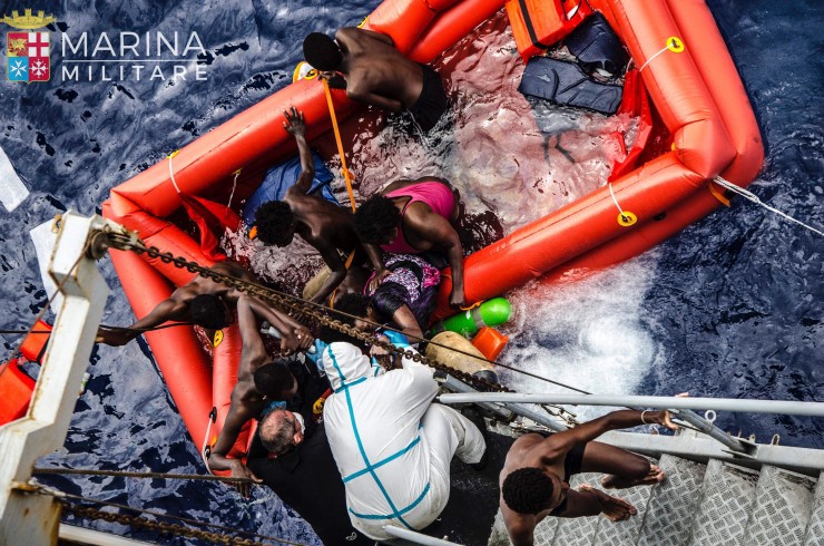 In this photo taken in the Mediterranean Sea, off the Libyan coast, Friday, May 27, 2016 rescuers help migrants to board the Italian Navy ship Vega, after the boat they were aboard sunk. The Italian navy says it has saved 135 migrants from a sinking boat and recovered 45 bodies in the Mediterranean. (Raffaele Martino/Marina Militare via AP Photo) CREDIT: Raffaele Martino/Marina Militare via AP Photo
