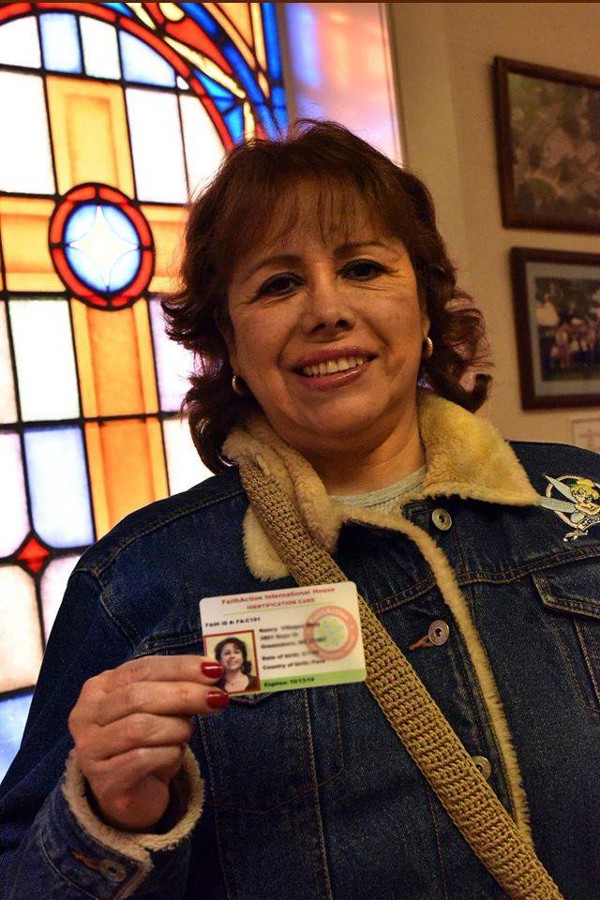 A woman with a FaithAction ID. CREDIT: FaithAction