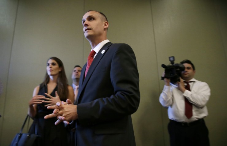 Campaign manager Corey Lewandowski, center, looks on as Republican presidential candidate Donald Trump speaks at a news conference, Tuesday, Aug. 25, 2015, in Dubuque, Iowa. CREDIT: AP Photo/Charlie Neibergall