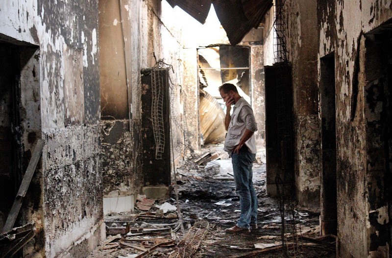 An employee of Doctors Without Borders walks inside the charred remains of the organization’s hospital after it was hit by a U.S. airstrike in Kunduz, Afghanistan, October 16, 2015. CREDIT: AP PHOTO/NAJIM RAHIM, FILE