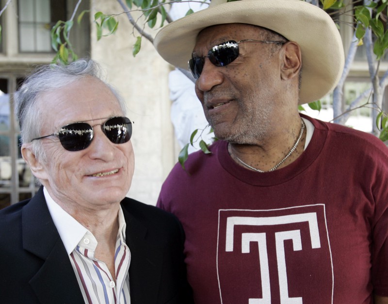 In this Feb. 27, 2008 file photo, Bill Cosby, perennial host of the Playboy Jazz Festival, right, and Playboy impresario Hugh Hefner greet each other at a party to announce the lineup of the upcoming 30th annual festival, at the Playboy Mansion in Los Angeles. CREDIT: AP PHOTO/REED SAXON