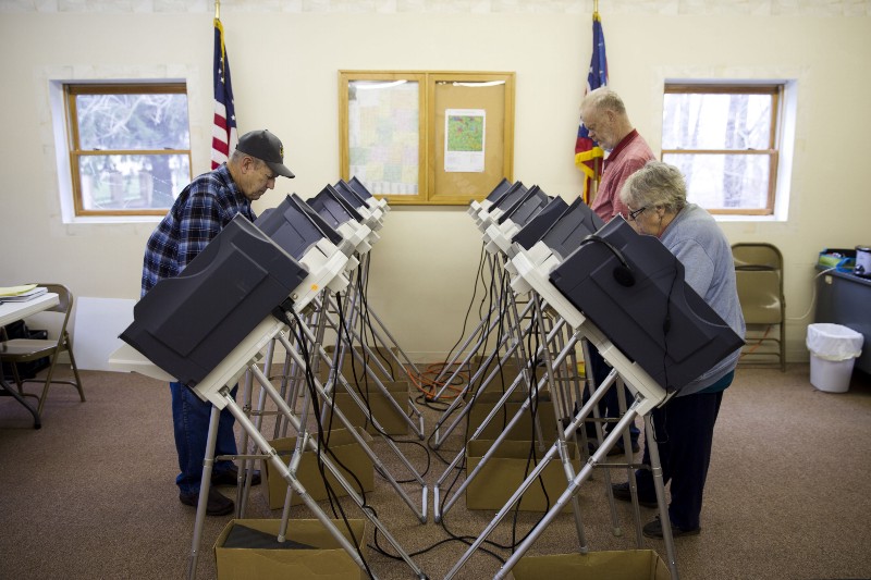 Voters cast ballots in the primary election in Chesterville, Ohio. CREDIT: AP PHOTO/MATT ROURKE