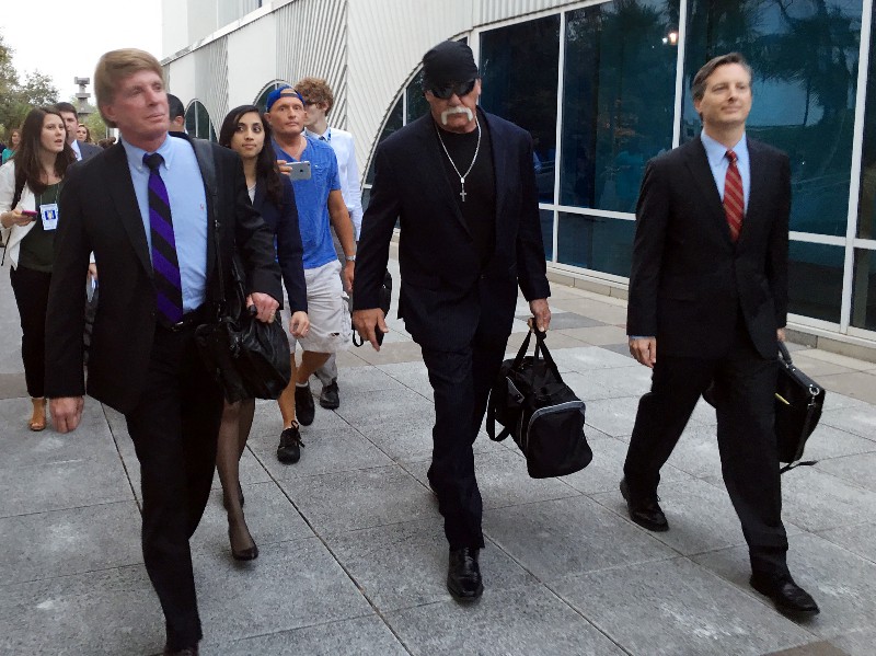 Hulk Hogan, center, whose given name is Terry Bollea, walks out of the Pinellas County courthouse after a jury sided with Hogan and awarded him $115 million in his sex tape lawsuit against Gawker Media. CREDIT: AP PHOTO/TAMARA LUSH