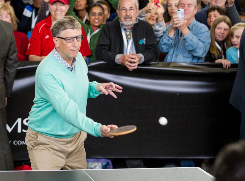 Microsoft co-founder Bill Gates plays table tennis against prodigy Ariel Hsing, unseen, along with Berkshire Hathaway Chairman and CEO Warren Buffett, unseen, outside the Borsheims jewelry store, a Berkshire Hathaway subsidiary, in Omaha, Neb., Sunday, May 1, 2016. CREDIT: AP PHOTO/JOHN PETERSON