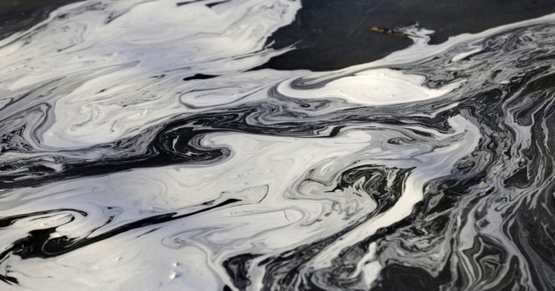 Coal ash swirls on the surface of the Dan River in 2014. CREDIT: AP PHOTO/GERRY BROOME