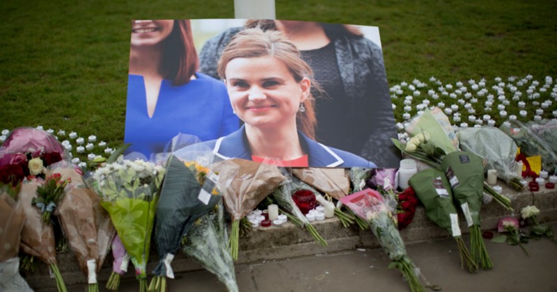 An image and floral tributes for Jo Cox, the 41-year-old British Member of Parliament shot to death yesterday in northern England, lie placed on Parliament Square outside the House of Parliament in London, Friday, June 17, 2016. CREDIT: AP PHOTO/MATT DUNHAM