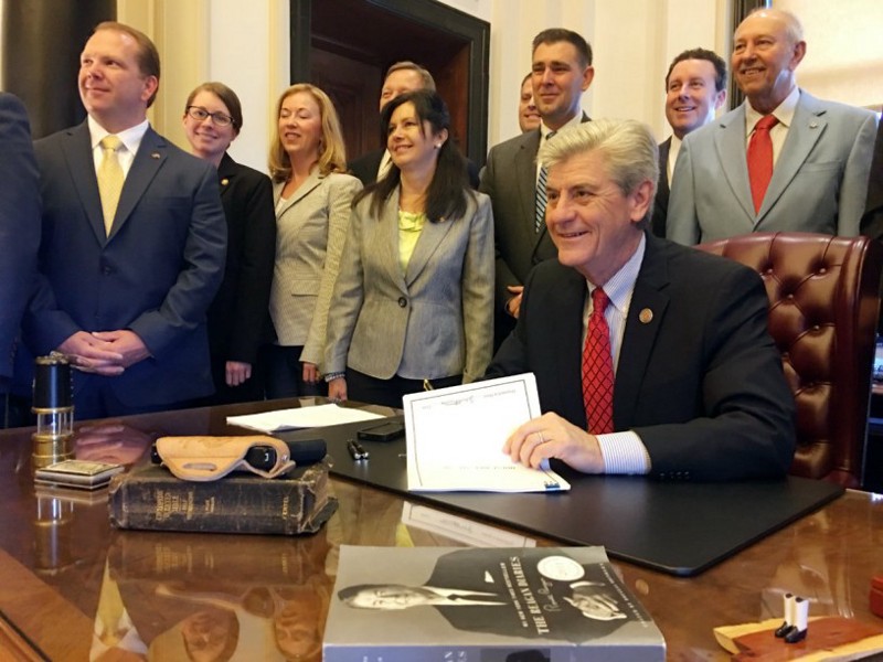 Mississippi Gov. Phil Bryant (R) signed a law in April loosening restrictions on guns in places of worship. CREDIT: Clay Chandler/Mississippi’s Governor’s Office via AP