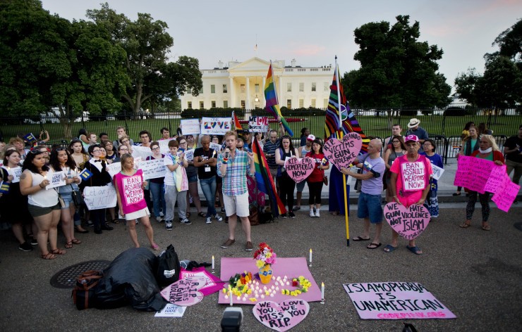 John Becker, center, speaks to fellow members and supporters of the LGBT as they gather for a candlelight vigil in front of the White House in Washington, Sunday, June 12, 2016 CREDIT: AP Photo/Manuel Balce Ceneta