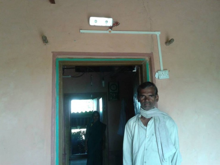 43-year old Tarabhai Lakshmi Koli and her husband (in front) proudly show their LED lights illuminating their house. CREDIT: Shravya Jain