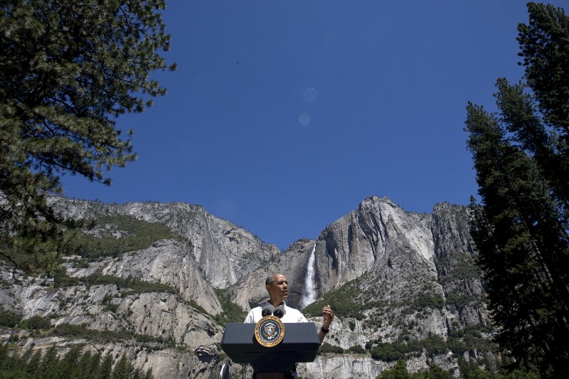 President Barack Obama speaks by the Sentinel Bridge, in the Yosemite Valley, in front of the Yosemite Falls which is the highest waterfall in the Park at Yosemite National Park, Calif., on Saturday, June 18, 2016. CREDIT: AP PHOTO/JACQUELYN MARTIN