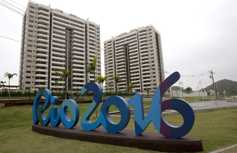 The Rio 2016 sign stands in front of the Olympic Village during a media tour in Rio de Janeiro, Brazil, Thursday, June 23, 2016. The organizers of the Rio de Janeiro Olympics have unveiled the athletes’ village, where nearly 11,000 competitors and some 6,000 coaches and other team members will stay during the Aug. 5–21 games. CREDIT: SILVIA IZQUIERDO, AP