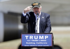 Republican presidential candidate Donald Trump gestures to a his camouflaged “Make America Great” hat. CREDIT: AP Photo/Rich Pedroncelli