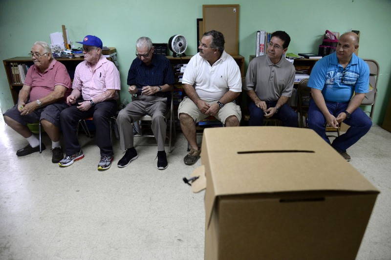 Puerto Rico residents wait to vote in the U.S. territory’s primary at a polling station in the Santurce county, in San Juan, Puerto Rico. CREDIT: AP PHOTO/CARLOS GIUSTI