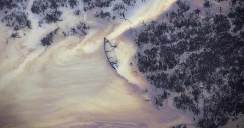 Oil is seen on the creek water’s surface near an illegal oil refinery in Ogoniland, outside Port Harcourt, in Nigeria’s Delta region. A region of Nigeria’s oil-rich southern delta suffers widespread ecological damage as spilled oil seeps into its drinking water, destroys plants and remains in the ground for decades at a time. CREDIT: AP PHOTO/SUNDAY ALAMBA