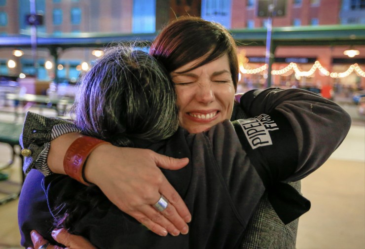 Jane Kleeb of Bold Nebraska hugs fellow activist Emily Levine of Lincoln. CREDIT: AP Photo/Nati Harnik