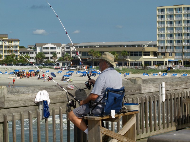 In this 2014 photo, a fisherman tries his luck on the pier at Folly Beach, near Charleston, S.C. Seismic testing would disrupt fish populations in the area. CREDIT: AP PHOTO/BRUCE SMITH, FILE