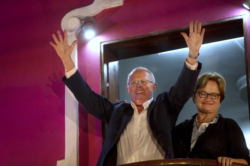 Presidential candidate Pedro Pablo Kuczynski greets supporters from the balcony of his party’s headquarters next to his wife Nancy Lange in Lima, Peru, Sunday, June 5, 2016. Early exit polls show presidential candidate Kuczynski with a slight lead over his rival Keiko Fujimori in Peru’s runoff presidential election. CREDIT: AP PHOTO/RODRIGO ABD