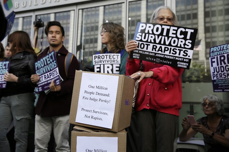 Activists from UltraViolet, a national womens advocacy organization, hold a rally before delivering over one million signatures to the California Commission on Judicial Performance calling for the removal of Judge Aaron Persky from the bench Friday, June 10, 2016, in San Francisco. CREDIT: AP PHOTO/ERIC RISBERG