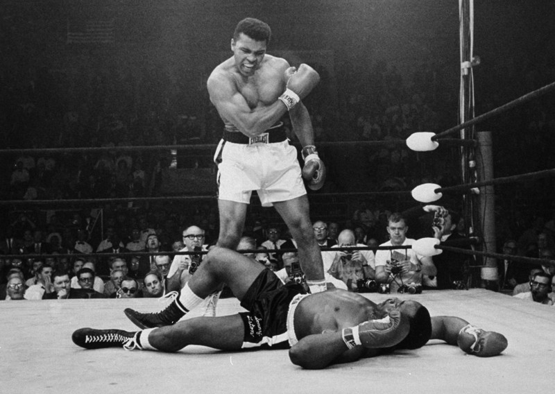 Heavyweight champion Muhammad Ali stands over fallen challenger Sonny Liston, shouting and gesturing shortly after dropping Liston with a short hard right to the jaw on May 25, 1965, in Lewiston, Maine. The bout lasted only one minute into the first round. CREDIT: JOHN ROONEY, AP