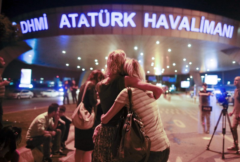 Passengers embrace each other at the entrance to Istanbul’s Ataturk airport, early Wednesday, June 29, 2016 following their evacuation after the blast. CREDIT: AP PHOTO/EMRAH GUREL