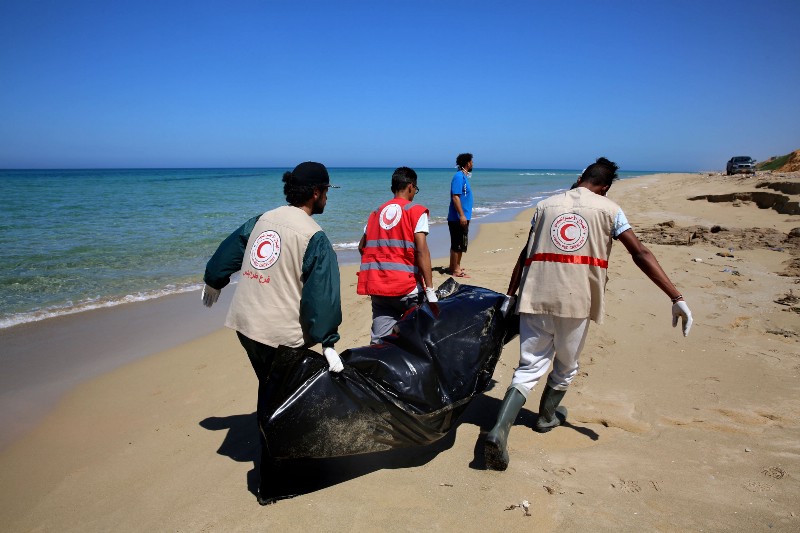 Libyan Red Crescent workers recover a body of a drowned migrant, off the shore of Gasr Garabulli, in the eastern city of Tripoli, Tuesday, March 29, 2016. Libyan Red Crescent workers collected 17 bodies since March 18 after a boat sank off the east coast of the city of Tripoli. (AP Photo/Mohamed Ben Khalifa) CREDIT: AP PHOTO/MOHAMED BEN KHALIFA