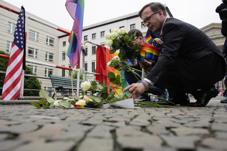 People lay down flowers during a vigil in front of the United States embassy in Berlin, German, Monday, June 13, 2016 CREDIT: AP Photo/Markus Schreiber