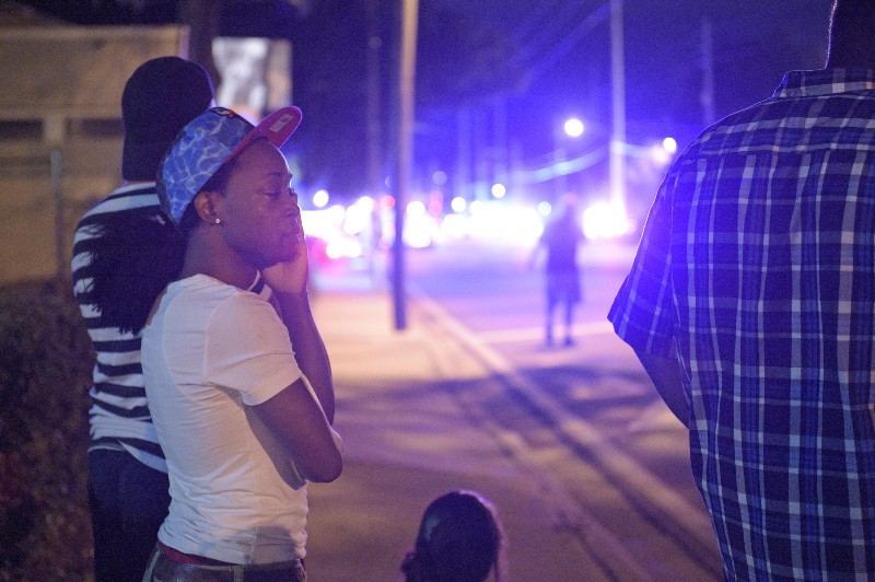 Jermaine Towns, left, waits down the street from the scene of a shooting involving multiple fatalities at a nightclub in Orlando, Fla., Sunday, June 12, 2016. Towns said his brother was hiding in a bathroom at the time. CREDIT: AP PHOTO/PHELAN M. EBENHACK