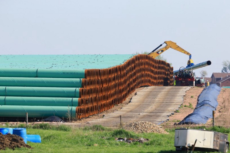 Pipes for the Dakota Access oil pipeline, that would stretch from the Bakken oil fields in North Dakota to Patoka, Ill., are stacked Saturday, May 9, 2015, at a staging area in Worthing, S.D. CREDIT: AP Photo/Nati Harnik