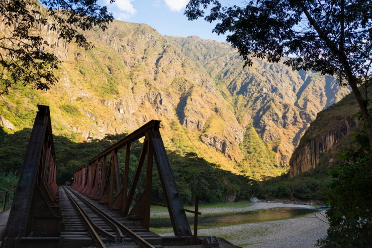 Iron bridge on the railroad track crossing jungle and Urubamba river, connecting Machu Picchu village to hydroelectric station. CREDIT: Shutterstock