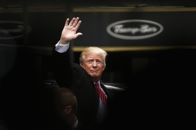 In this April 9, 2016 file photo, Republican presidential candidate Donald Trump acknowledges supporters while leaving Trump Tower in New York. CREDIT: AP PHOTO/JULIO CORTEZ