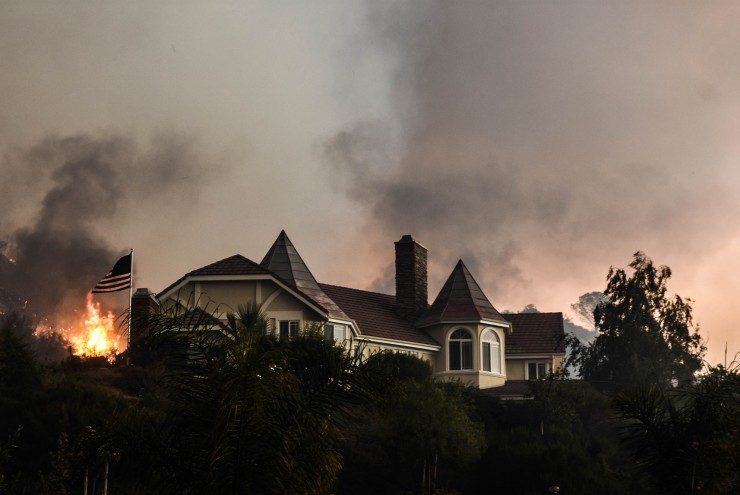 A wildfire burns close to a home near Sand Caynon and Placerita Caynon in Santa Clarita, Calif., Saturday, July 23, 2016. CREDIT: AP Photo/Ryan Babroff