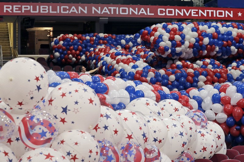Dave Strnisa, left, moves a bag of balloons as preparations continue for the Republican National Convention, Friday, July 15, 2016, at the Quicken Loans Arena in Cleveland. CREDIT: ALEX BRANDON, AP