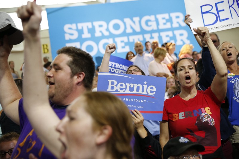 Supporters for Democratic presidential candidates Hillary Clinton and Sen. Bernie Sanders, I-Vt. cheer before a rally in Portsmouth, N.H., Tuesday, July 12, 2016, prior to the arrival of Clinton and Sanders. Sanders is poised to offer his long-awaited endorsement of Clinton, hoping to transfer the energy of his supporters into the party’s fight against Republican Donald Trump. CREDIT: AP PHOTO/ANDREW HARNIK