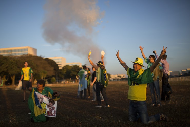 Anti-government demonstrators celebrate the result of the impeachment process outside Congress in Brasilia, Brazil, Thursday, May 12, 2016. CREDIT: Felipe Dana, AP