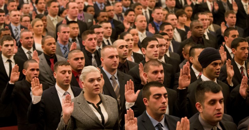 New recruits take the oath to during the New York City Police Department swearing-in ceremony, Thursday, Jan. 7, 2016, at Queens College in the Queens borough of New York. CREDIT: AP PHOTO/MARY ALTAFFER
