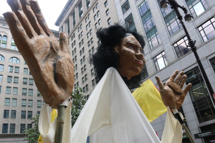 A massive puppet figure representing murdered Honduran environmentalist floats through the streets outside the DNC. CREDIT: Grassroots Global Justice Alliance