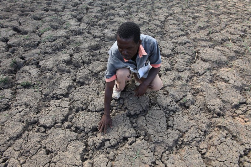 Last Zimaniwa feels the broken ground at a spot which is usually a reliable water source in the village of Chivi , Zimbabwe. The United States on Monday announced $127 million in aid for southern African countries where the worst drought in decades is affecting millions of people. CREDIT: AP Photo/Tsvangirayi Mukwazhi,