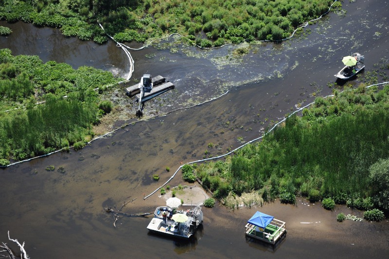 In a July 13, 2011 file photo, cleanup work continues on the Kalamzoo River almost a year after a spill near Marshall, Mich. CREDIT: AP PHOTO/JOE RAYMOND
