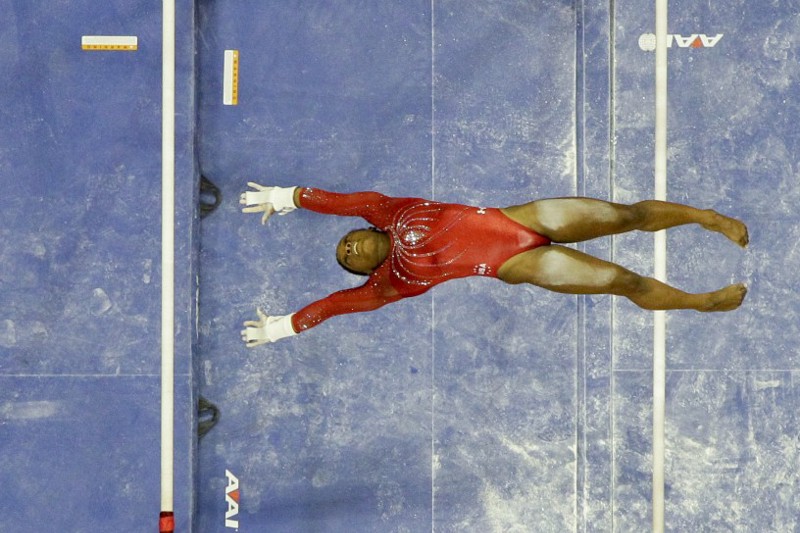 Simone Biles competes on the uneven bars during the women’s U.S. Olympic gymnastics trials in San Jose, Calif., Sunday, July 10, 2016. CREDIT: AP Photo/Gregory Bull