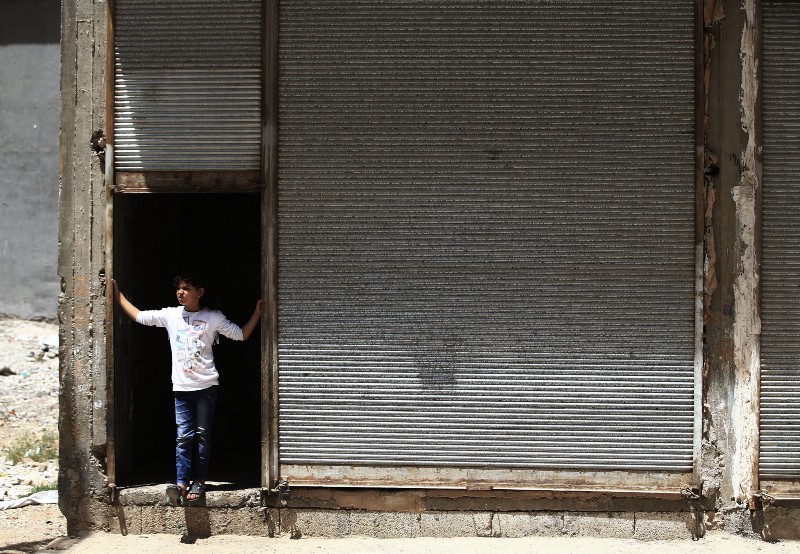 A Syrian refugee child stands outside a commercial space that her family has rented to live in, in a neighborhood of the city of Gaziantep, southeastern Turkey, Monday, May 16, 2016. CREDIT: AP PHOTO/LEFTERIS PITARAKIS