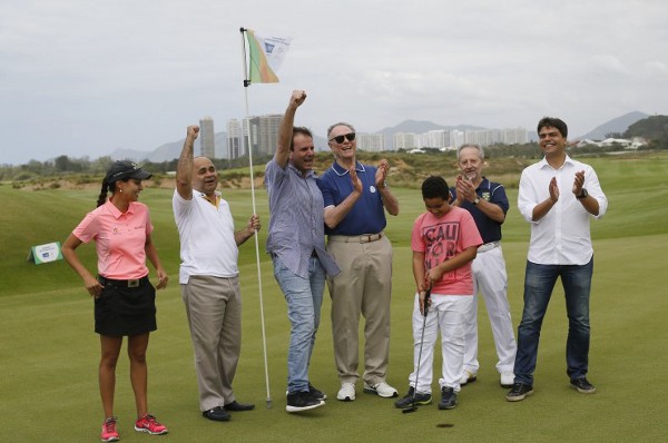 Eduardo Paes, third left, and Brazil Olympic Committee President Carlos Nuzman, center, celebrate during a ceremony at the Olympic Golf Course in Rio de Janeiro, Sunday, Nov. 22, 2015.