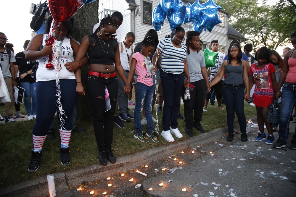 Family members of Sylville Smith gather where he was shot and killed by Milwaukee Police. CREDIT: AP Photo/JEFFREY PHELPS