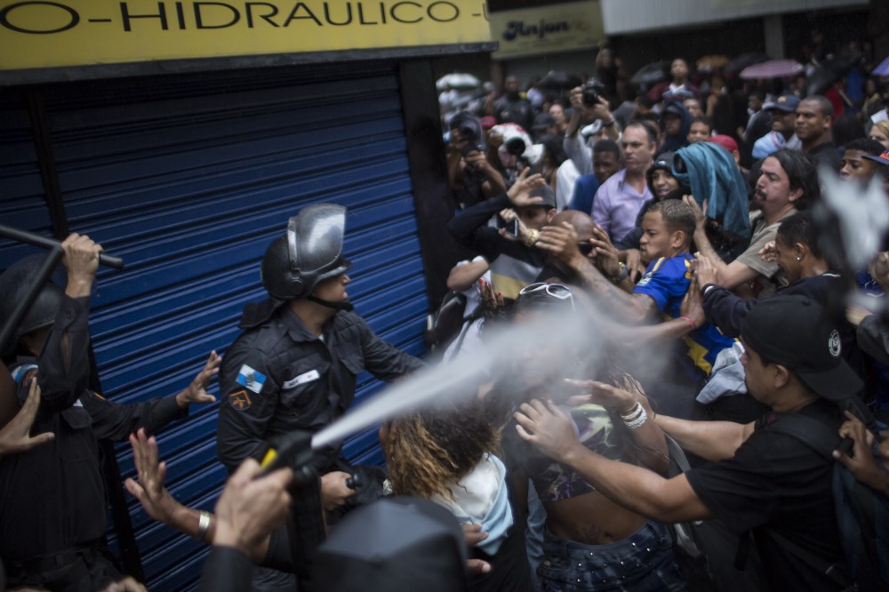 Residents of Pavao-Pavaozinho slum clash with riot police during a protest against the death of Douglas Rafael da Silva Pereira after his burial in Rio de Janeiro, Brazil. CREDIT: AP PHOTO/FELIPE DANA