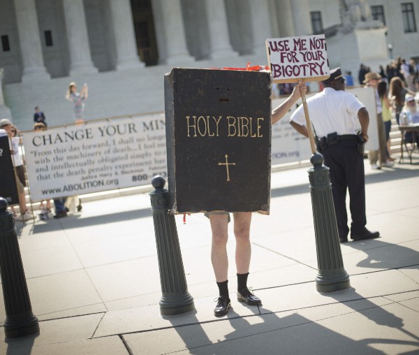 A protester offers a different view than the one expressed by Judge Sean Cox in a recent opinion. (CREDIT:(AP PHOTO/PABLO MARTINEZ MONSIVAIS)