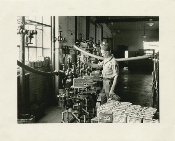 A worker fills oil cans at the Sinclair Oil Refinery in East Chicago in the early 1900s. CREDIT: THE NEW YORK PUBLIC LIBRARY