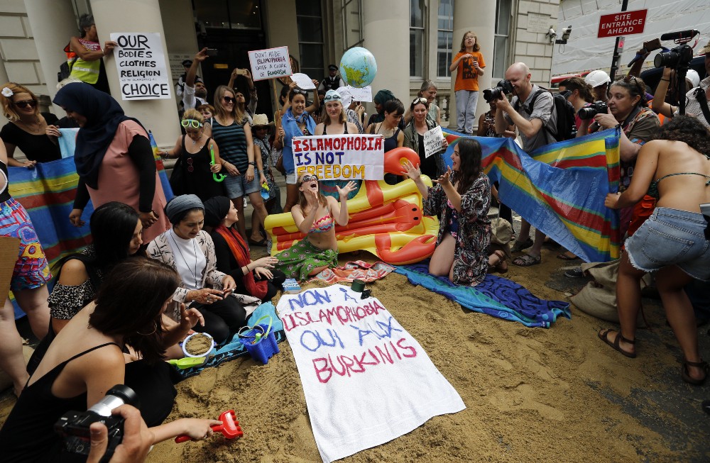 Activists protest outside the French embassy during, the “wear what you want beach party” in London, Thursday, Aug. 25, 2016. The protest is against the French authorities clampdown on Muslim women wearing burkinis on the beach. CREDIT: AP Photo/Frank Augstein