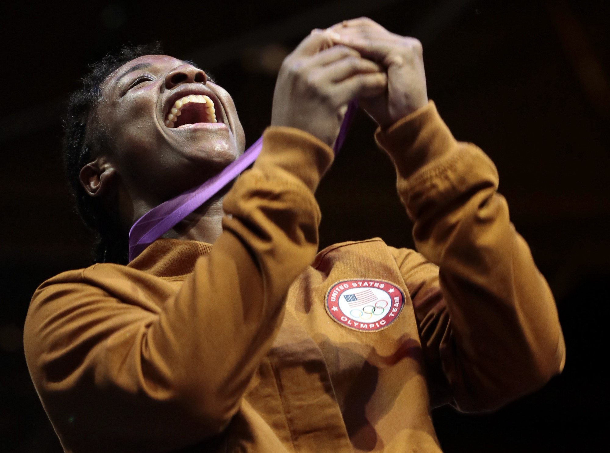 Claressa Shields with her gold medal in London 2012 CREDIT: IVAN SEKRETAREV, AP
