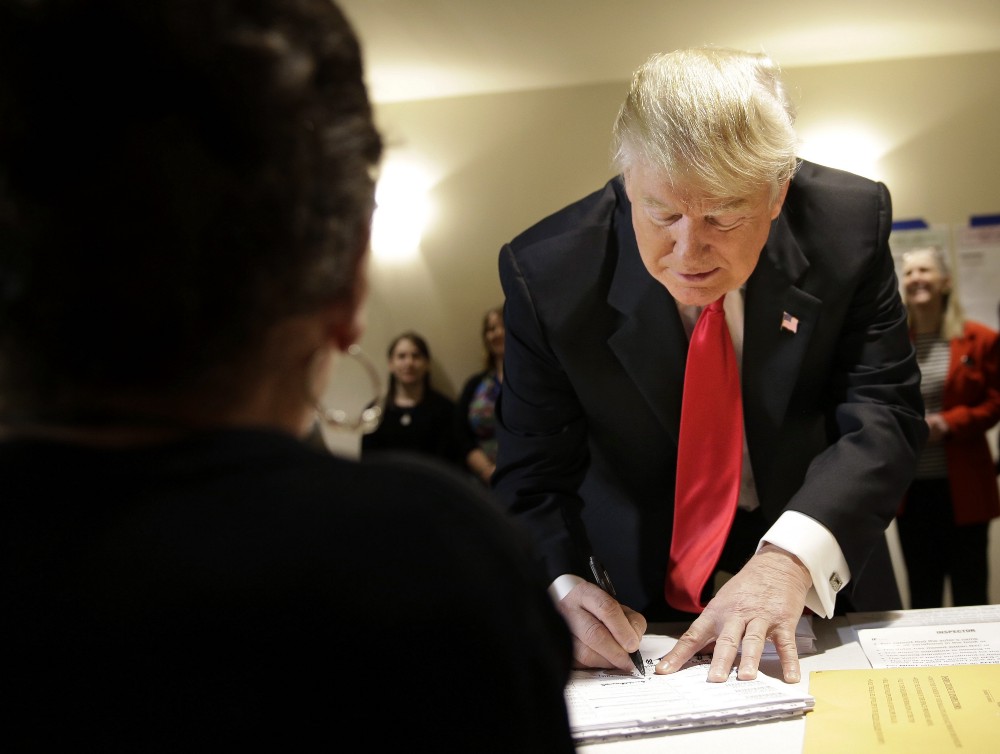 Republican presidential candidate Donald Trump fills out paperwork at his polling place in New York, Tuesday, April 19, 2016. CREDIT: AP Photo/Seth Wenig