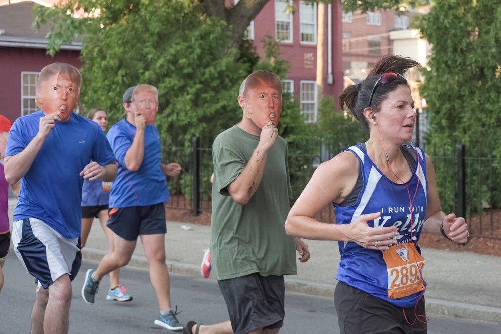 Climate activists wearing Trump masks chased Ayotte while she ran a 5K last week. CREDIT: 350 ACTION